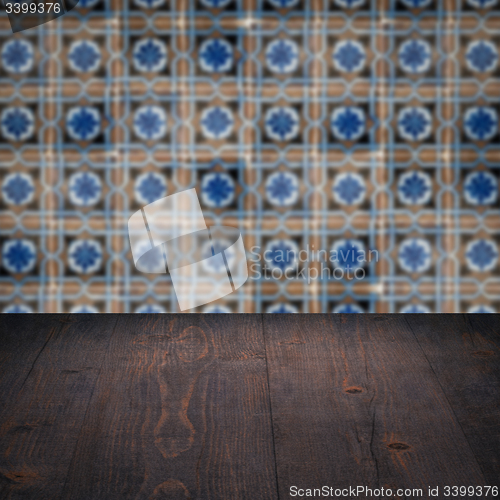 Image of Wood table top and blur vintage ceramic tile pattern wall