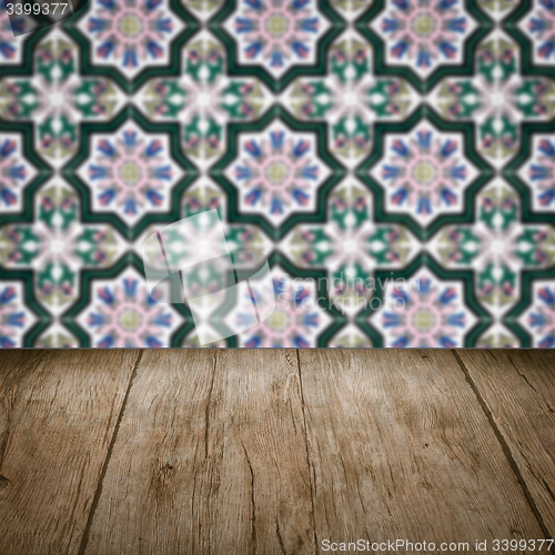 Image of Wood table top and blur vintage ceramic tile pattern wall