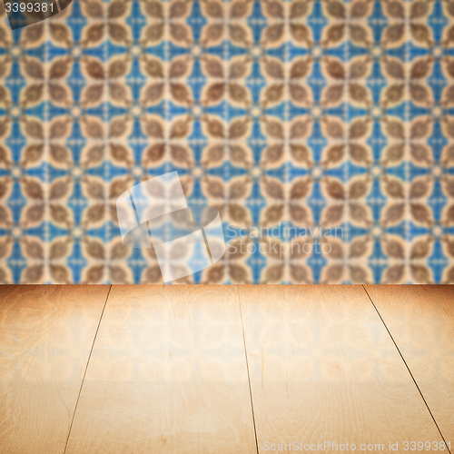 Image of Wood table top and blur vintage ceramic tile pattern wall
