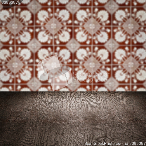 Image of Wood table top and blur vintage ceramic tile pattern wall