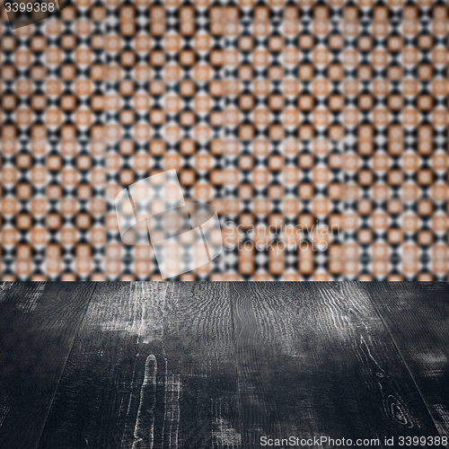 Image of Wood table top and blur vintage ceramic tile pattern wall