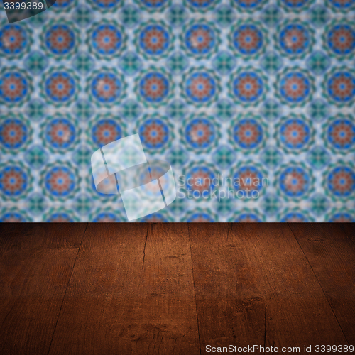 Image of Wood table top and blur vintage ceramic tile pattern wall