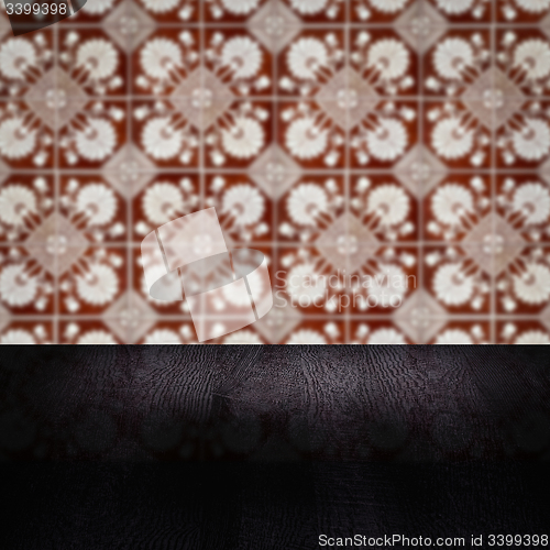 Image of Wood table top and blur vintage ceramic tile pattern wall
