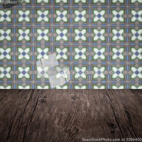 Image of Wood table top and blur vintage ceramic tile pattern wall