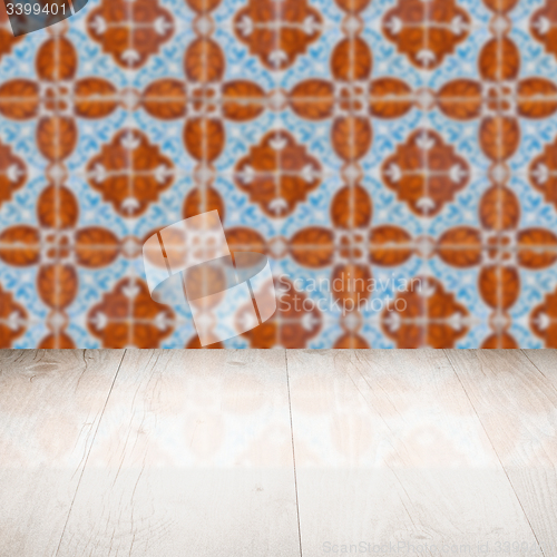 Image of Wood table top and blur vintage ceramic tile pattern wall