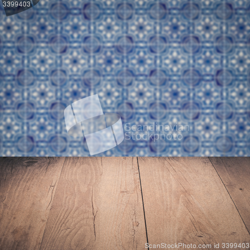 Image of Wood table top and blur vintage ceramic tile pattern wall