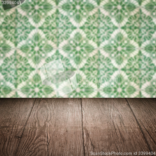 Image of Wood table top and blur vintage ceramic tile pattern wall