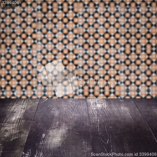 Image of Wood table top and blur vintage ceramic tile pattern wall