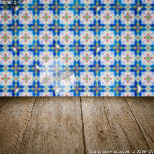 Image of Wood table top and blur vintage ceramic tile pattern wall