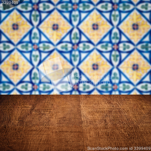 Image of Wood table top and blur vintage ceramic tile pattern wall