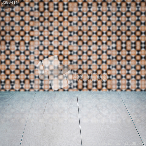 Image of Wood table top and blur vintage ceramic tile pattern wall