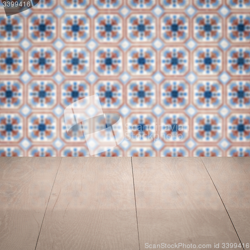 Image of Wood table top and blur vintage ceramic tile pattern wall