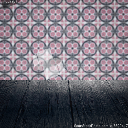 Image of Wood table top and blur vintage ceramic tile pattern wall