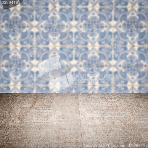 Image of Wood table top and blur vintage ceramic tile pattern wall