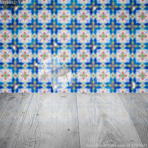 Image of Wood table top and blur vintage ceramic tile pattern wall