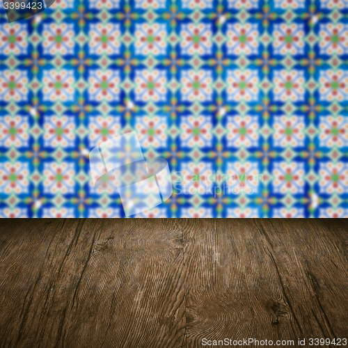 Image of Wood table top and blur vintage ceramic tile pattern wall