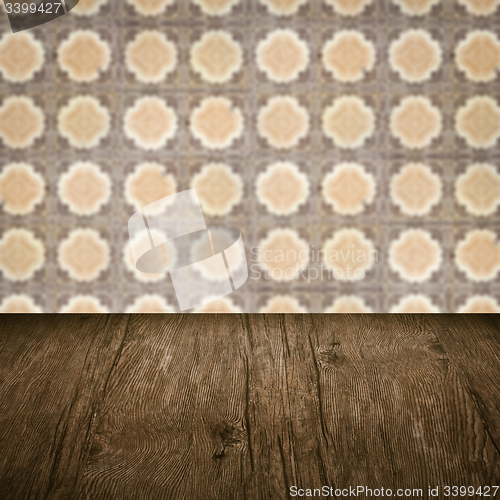Image of Wood table top and blur vintage ceramic tile pattern wall