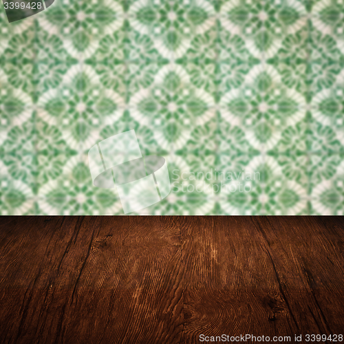 Image of Wood table top and blur vintage ceramic tile pattern wall