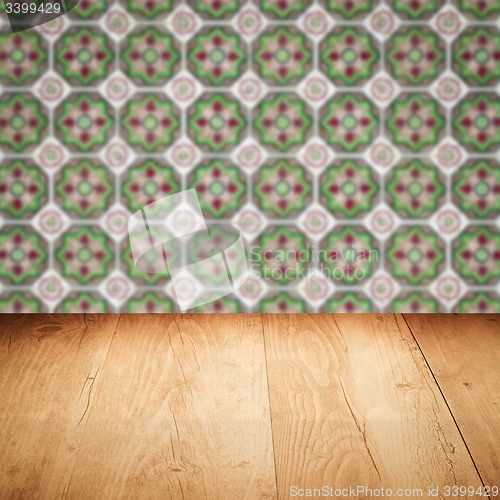 Image of Wood table top and blur vintage ceramic tile pattern wall