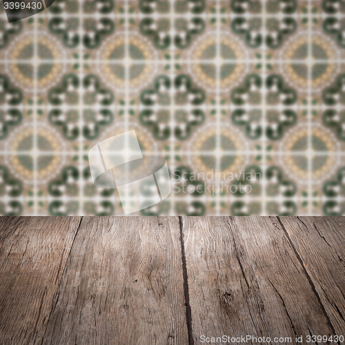 Image of Wood table top and blur vintage ceramic tile pattern wall