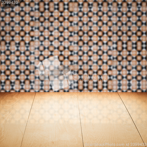 Image of Wood table top and blur vintage ceramic tile pattern wall