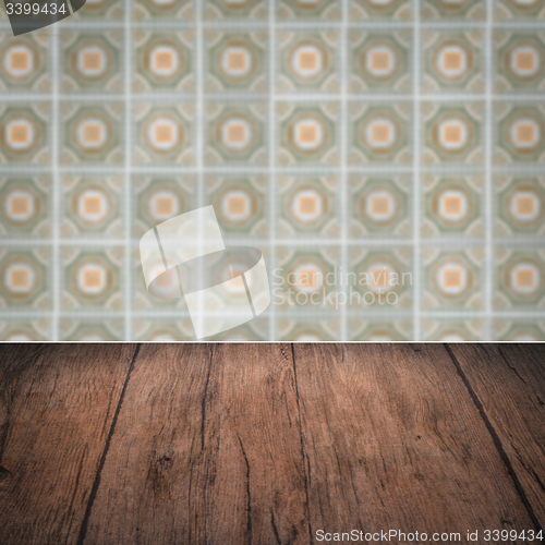 Image of Wood table top and blur vintage ceramic tile pattern wall