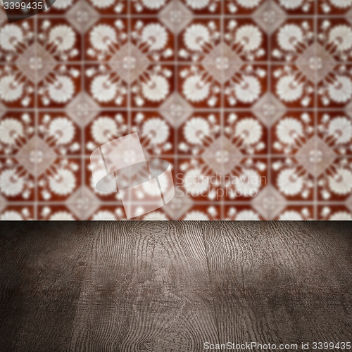 Image of Wood table top and blur vintage ceramic tile pattern wall