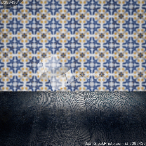 Image of Wood table top and blur vintage ceramic tile pattern wall