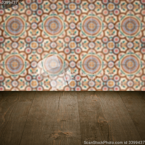 Image of Wood table top and blur vintage ceramic tile pattern wall