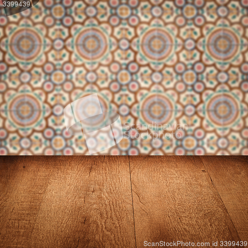 Image of Wood table top and blur vintage ceramic tile pattern wall