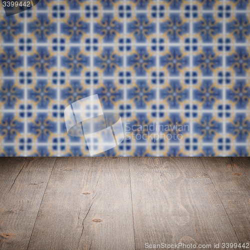 Image of Wood table top and blur vintage ceramic tile pattern wall