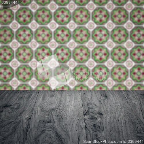 Image of Wood table top and blur vintage ceramic tile pattern wall