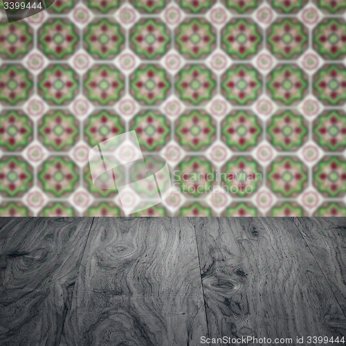 Image of Wood table top and blur vintage ceramic tile pattern wall