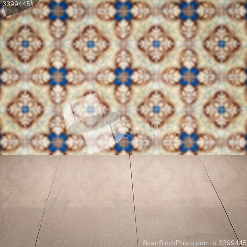 Image of Wood table top and blur vintage ceramic tile pattern wall