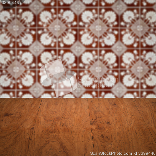 Image of Wood table top and blur vintage ceramic tile pattern wall