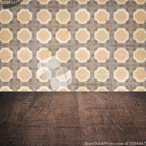 Image of Wood table top and blur vintage ceramic tile pattern wall