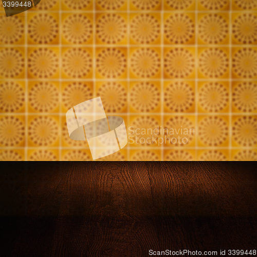 Image of Wood table top and blur vintage ceramic tile pattern wall