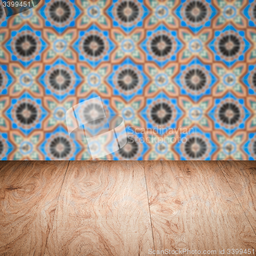 Image of Wood table top and blur vintage ceramic tile pattern wall