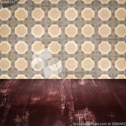Image of Wood table top and blur vintage ceramic tile pattern wall
