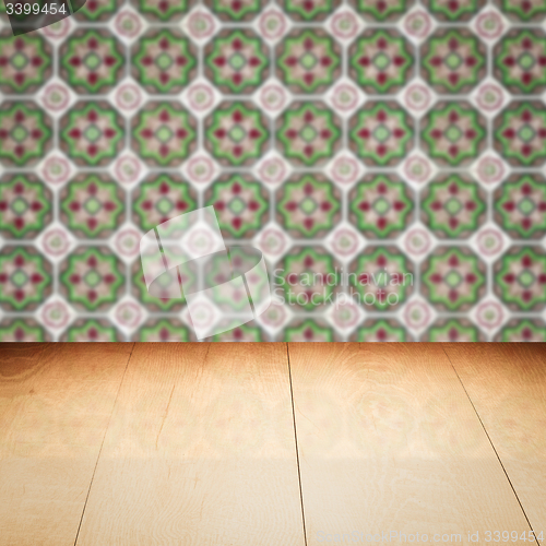 Image of Wood table top and blur vintage ceramic tile pattern wall