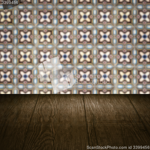 Image of Wood table top and blur vintage ceramic tile pattern wall