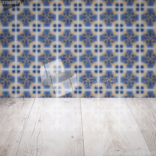 Image of Wood table top and blur vintage ceramic tile pattern wall