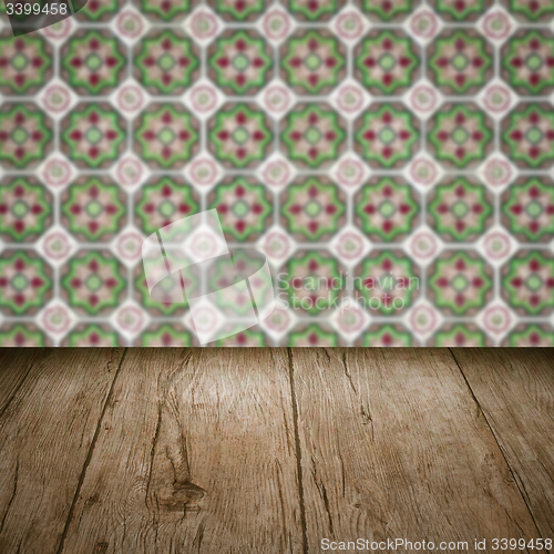 Image of Wood table top and blur vintage ceramic tile pattern wall