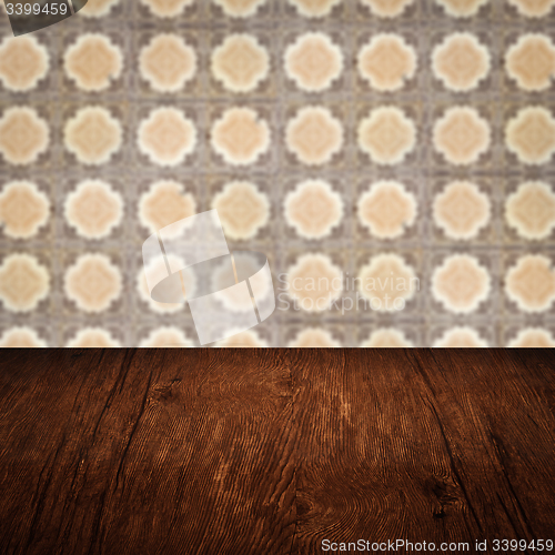 Image of Wood table top and blur vintage ceramic tile pattern wall