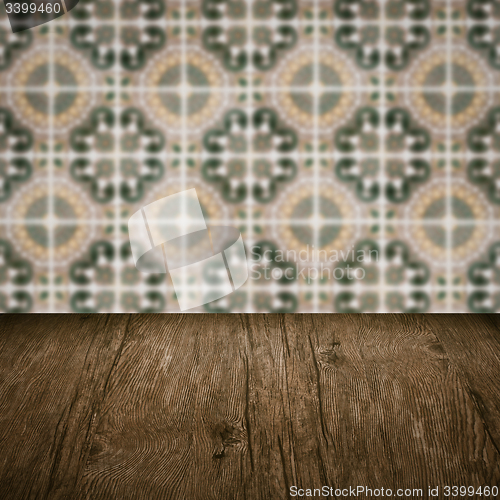 Image of Wood table top and blur vintage ceramic tile pattern wall