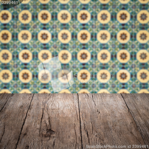 Image of Wood table top and blur vintage ceramic tile pattern wall