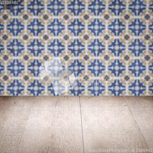 Image of Wood table top and blur vintage ceramic tile pattern wall