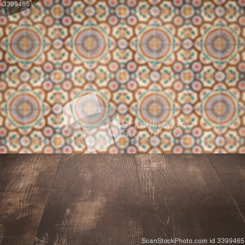 Image of Wood table top and blur vintage ceramic tile pattern wall