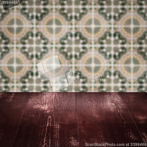 Image of Wood table top and blur vintage ceramic tile pattern wall