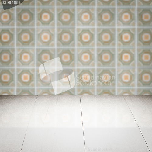 Image of Wood table top and blur vintage ceramic tile pattern wall